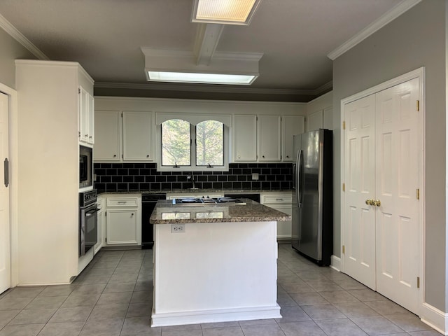 kitchen featuring backsplash, a center island, light tile patterned floors, and black appliances