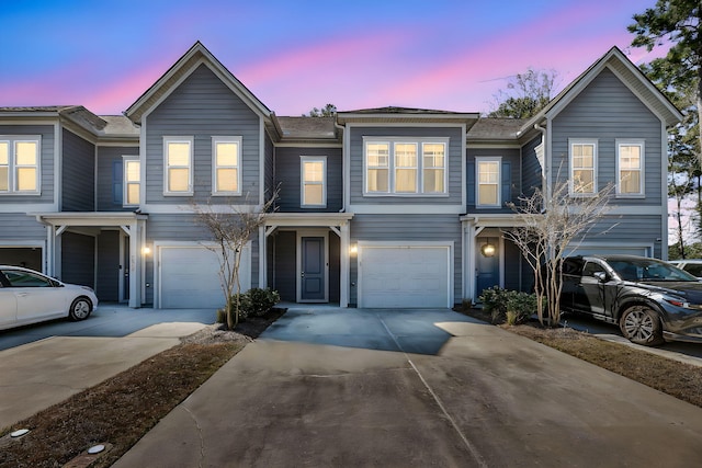 townhome / multi-family property featuring a garage and concrete driveway