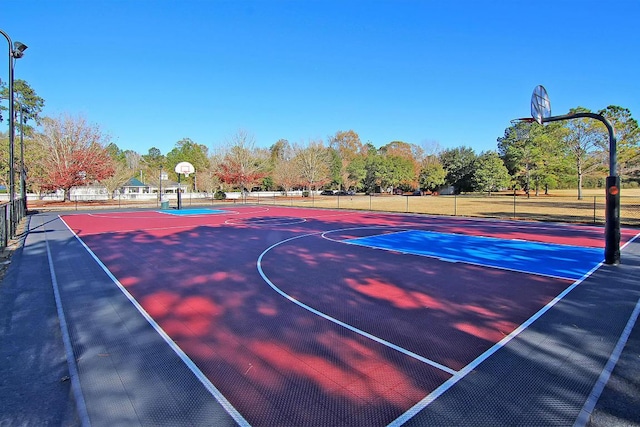 8662 W Fairway Woods Dr, North Charleston, SC 29420 - view of sport court with community basketball court, fence, and view of wooded area