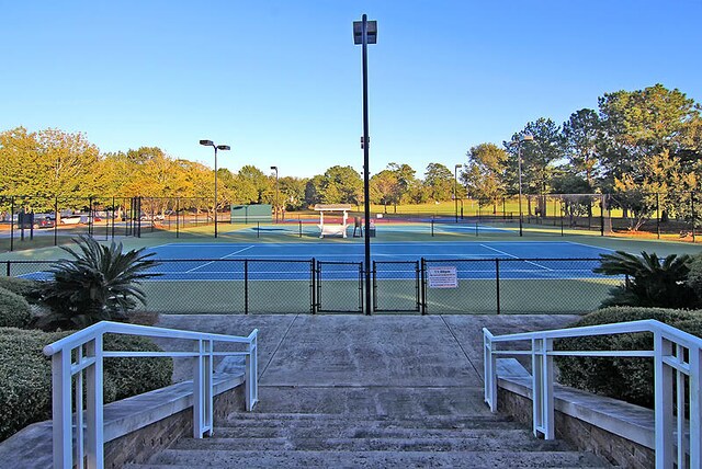 8662 W Fairway Woods Dr, North Charleston, SC 29420 - view of tennis court with fence and a gate