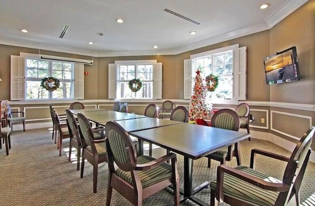 8662 W Fairway Woods Dr, North Charleston, SC 29420 - dining space with carpet, crown molding, recessed lighting, and a decorative wall
