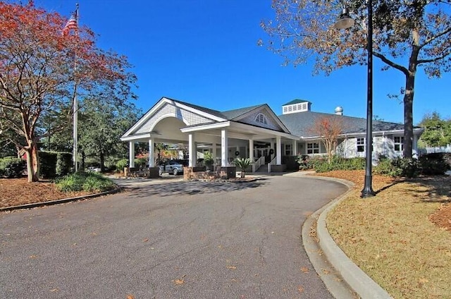 8662 W Fairway Woods Dr, North Charleston, SC 29420 - view of front of house featuring a porch and asphalt driveway