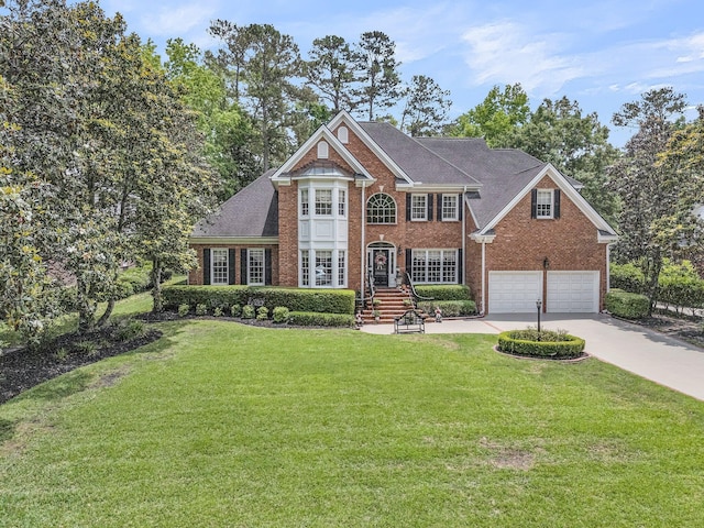 8662 W Fairway Woods Dr, North Charleston, SC 29420 - colonial-style house with brick siding, concrete driveway, a front yard, and a garage