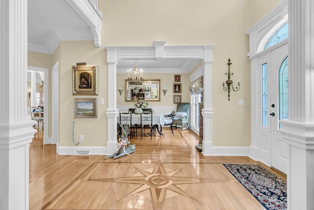 8662 W Fairway Woods Dr, North Charleston, SC 29420 - entrance foyer featuring decorative columns, crown molding, light wood-style floors, a chandelier, and baseboards