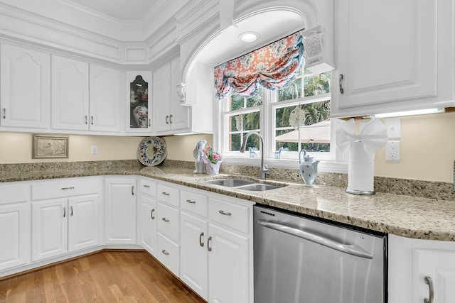 8662 W Fairway Woods Dr, North Charleston, SC 29420 - kitchen featuring stainless steel dishwasher, a sink, white cabinetry, light stone countertops, and crown molding