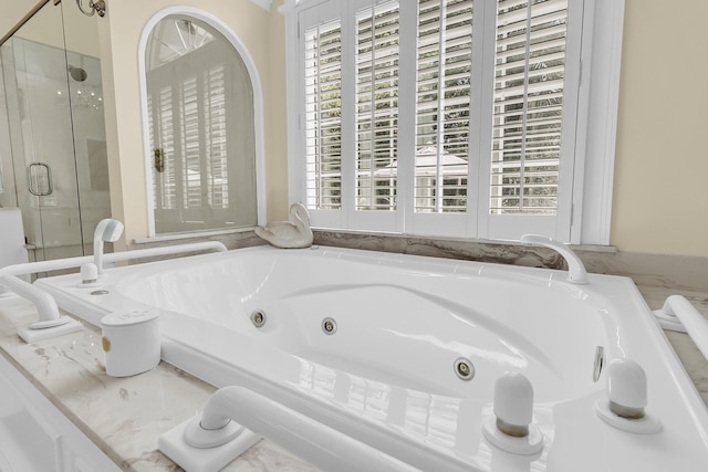 8662 W Fairway Woods Dr, North Charleston, SC 29420 - bathroom featuring a tub with jets and a stall shower