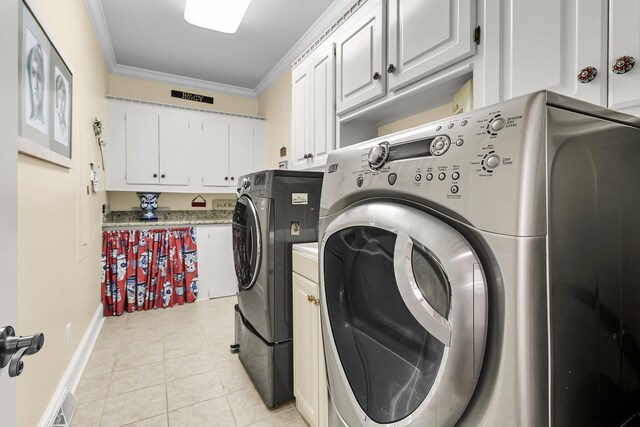 8662 W Fairway Woods Dr, North Charleston, SC 29420 - laundry room with washing machine and clothes dryer, cabinet space, light tile patterned floors, ornamental molding, and baseboards