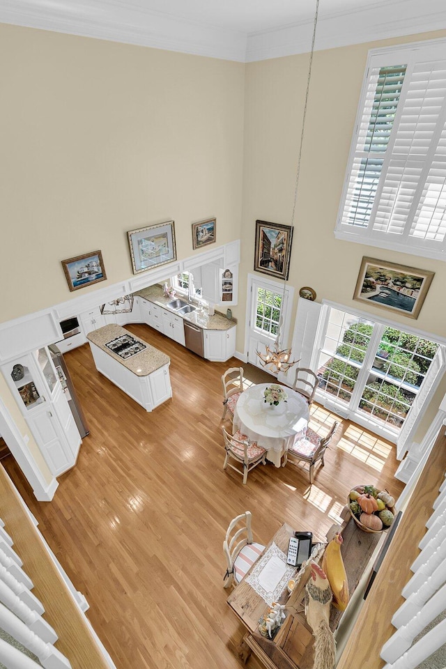 8662 W Fairway Woods Dr, North Charleston, SC 29420 - living area with a towering ceiling, crown molding, and light wood-type flooring