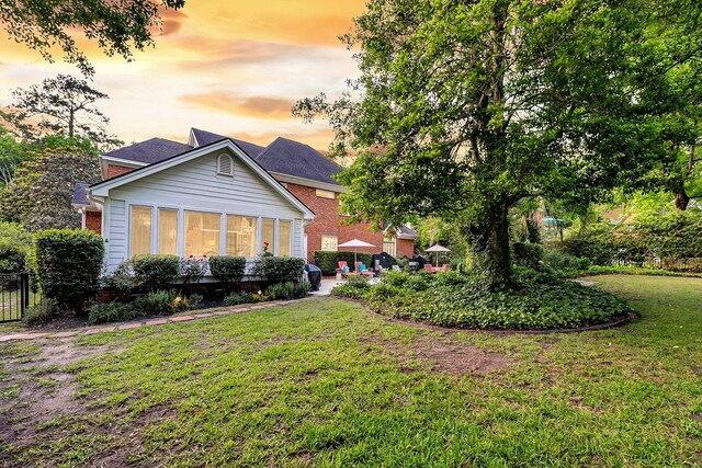 8662 W Fairway Woods Dr, North Charleston, SC 29420 - back of house with a yard and brick siding