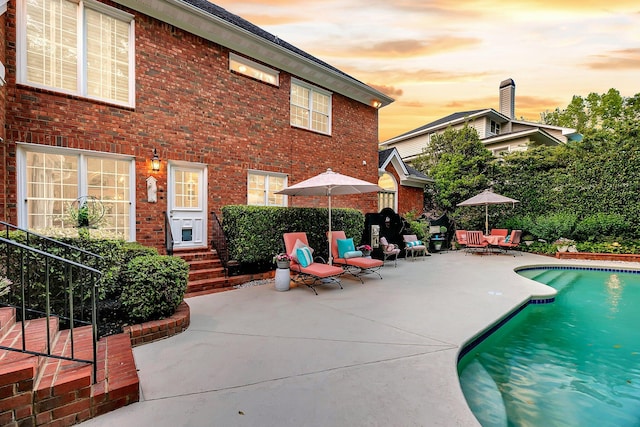 8662 W Fairway Woods Dr, North Charleston, SC 29420 - pool at dusk with a patio and entry steps