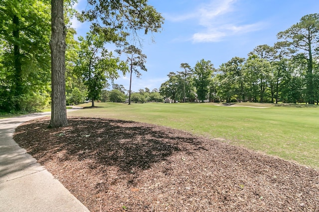 8662 W Fairway Woods Dr, North Charleston, SC 29420 - view of home's community with a lawn, view of wooded area, and golf course view