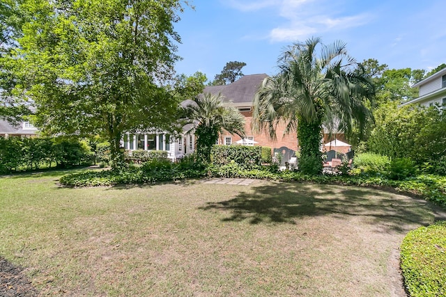 8662 W Fairway Woods Dr, North Charleston, SC 29420 - view of front of house featuring a front yard and brick siding