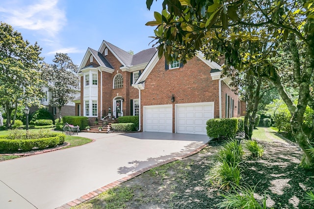 8662 W Fairway Woods Dr, North Charleston, SC 29420 - view of front of home featuring brick siding, concrete driveway, and a garage