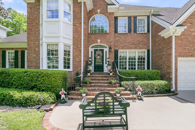 8662 W Fairway Woods Dr, North Charleston, SC 29420 - property entrance featuring brick siding and roof with shingles