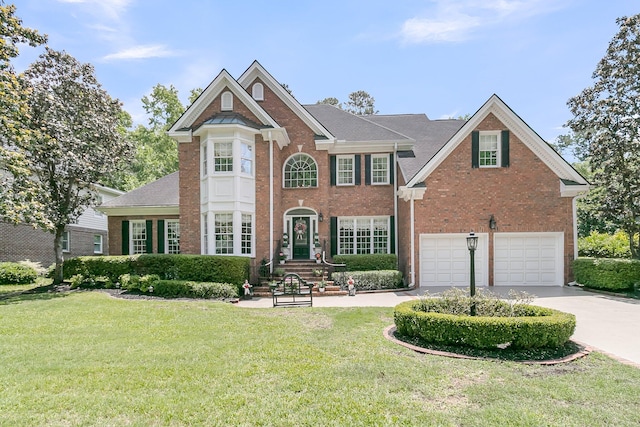 8662 W Fairway Woods Dr, North Charleston, SC 29420 - view of front of house featuring brick siding, driveway, a front lawn, and a garage