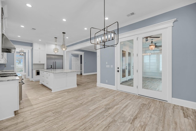 kitchen featuring visible vents, appliances with stainless steel finishes, a chandelier, and white cabinetry