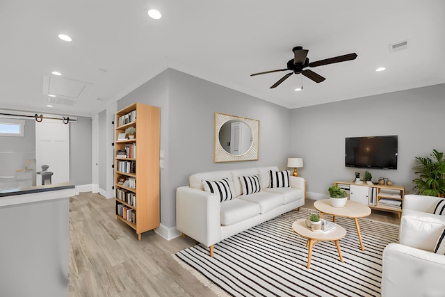 living area featuring visible vents, ceiling fan, attic access, recessed lighting, and light wood-style floors