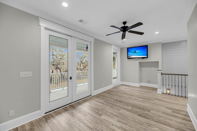 unfurnished room featuring french doors, baseboards, visible vents, and wood finished floors