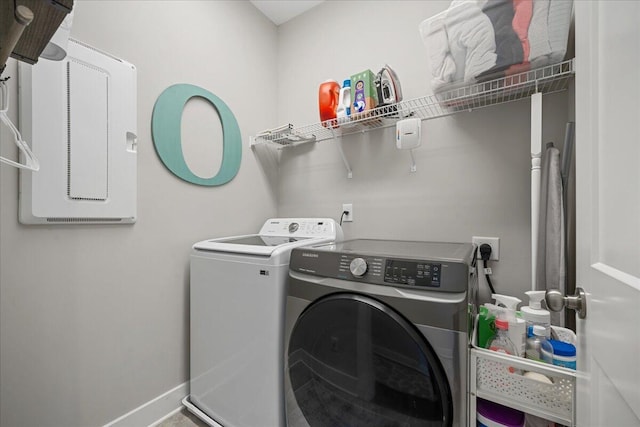 clothes washing area with washing machine and clothes dryer