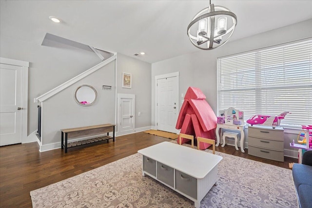 recreation room with dark hardwood / wood-style flooring and a chandelier