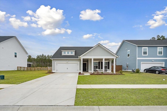 view of front of home with a porch, concrete driveway, fence, a garage, and a front lawn