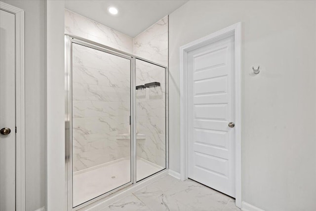 full bath featuring recessed lighting, marble finish floor, baseboards, and a marble finish shower