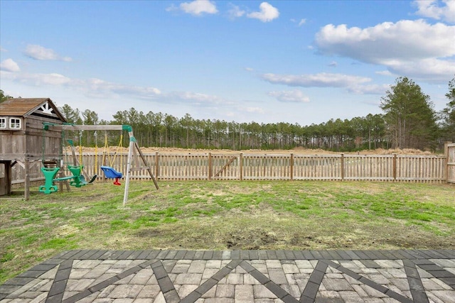 view of yard with a fenced backyard, a playground, and a patio