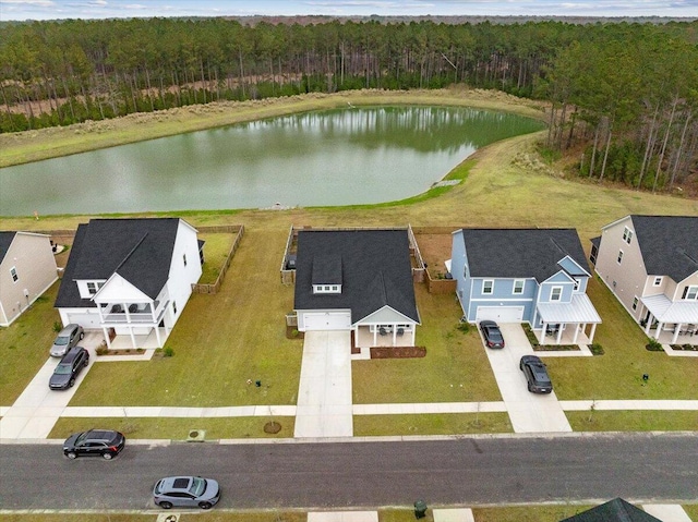 bird's eye view featuring a water view and a wooded view