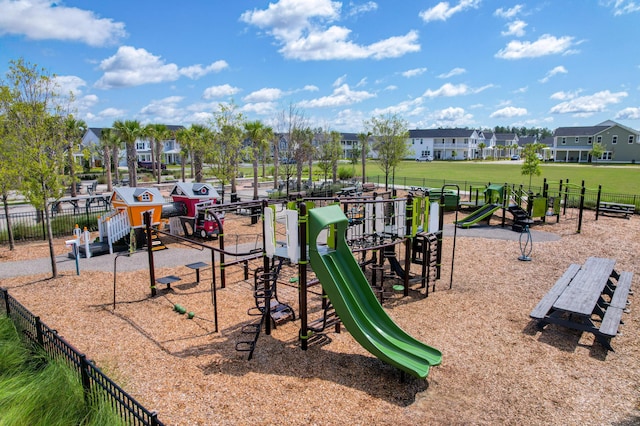 community jungle gym featuring a residential view and fence