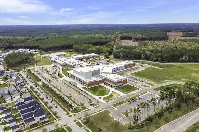 birds eye view of property with a view of trees