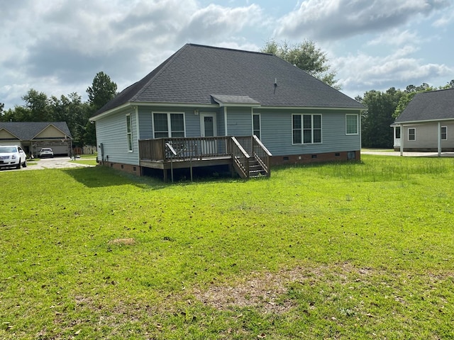 rear view of house with a deck and a lawn