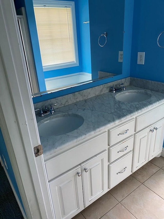 bathroom with tile patterned flooring and vanity