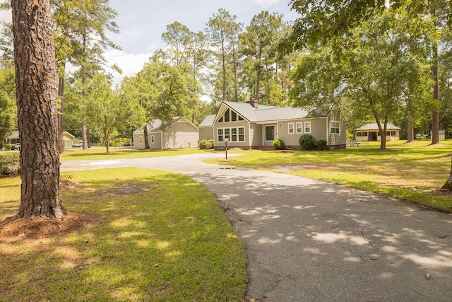 1044 Academy Rd, Walterboro, SC 29488 - view of front of house with curved driveway, a front lawn, and metal roof