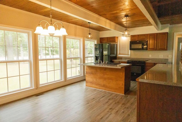 1044 Academy Rd, Walterboro, SC 29488 - kitchen featuring black appliances, wood ceiling with exposed beams, brown cabinetry, light wood finished floors, and healthy amount of natural light
