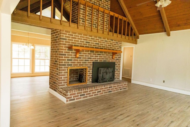 1044 Academy Rd, Walterboro, SC 29488 - unfurnished living room featuring a fireplace, wood finished floors, high vaulted ceiling, wood ceiling with exposed beams, and baseboards