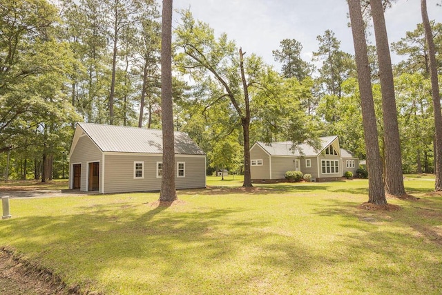 1044 Academy Rd, Walterboro, SC 29488 - view of grassy yard featuring an outbuilding, view of wooded area, and a garage