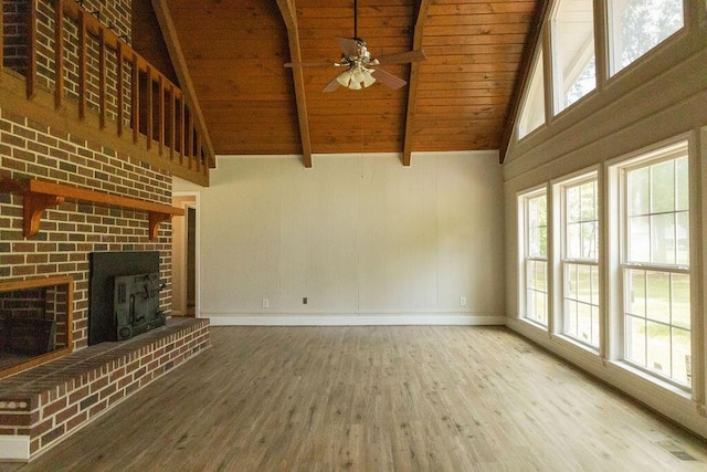 1044 Academy Rd, Walterboro, SC 29488 - unfurnished living room featuring wood ceiling with exposed beams, wood finished floors, a ceiling fan, healthy amount of natural light, and baseboards