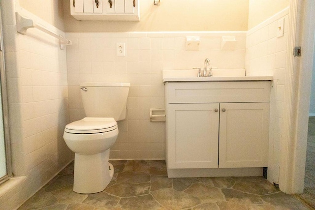 1044 Academy Rd, Walterboro, SC 29488 - bathroom featuring vanity, toilet, tile walls, and wainscoting