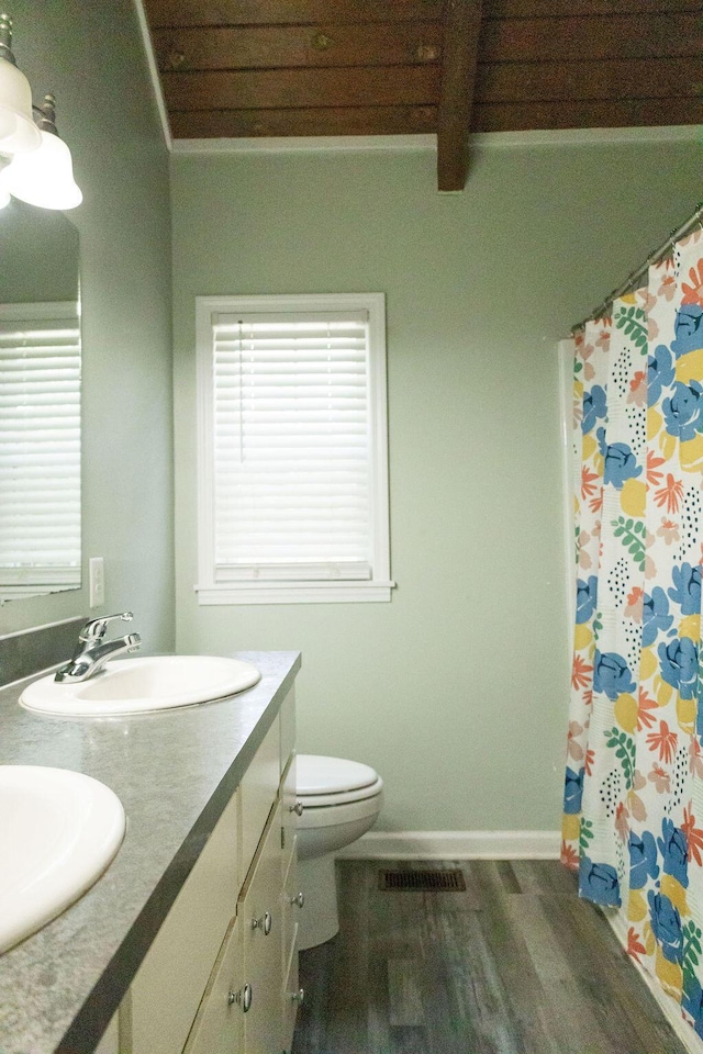 1044 Academy Rd, Walterboro, SC 29488 - full bathroom with double vanity, plenty of natural light, toilet, wood finished floors, and beamed ceiling
