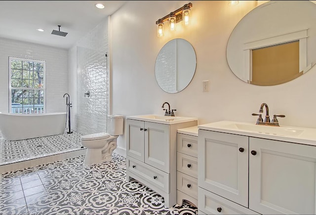 5681 Captain Kidd Rd, Hollywood, SC 29449 - full bath featuring two vanities, a freestanding tub, tile patterned flooring, recessed lighting, and a shower