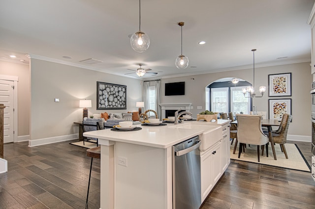 kitchen with dishwasher, dark hardwood / wood-style floors, white cabinetry, hanging light fixtures, and an island with sink