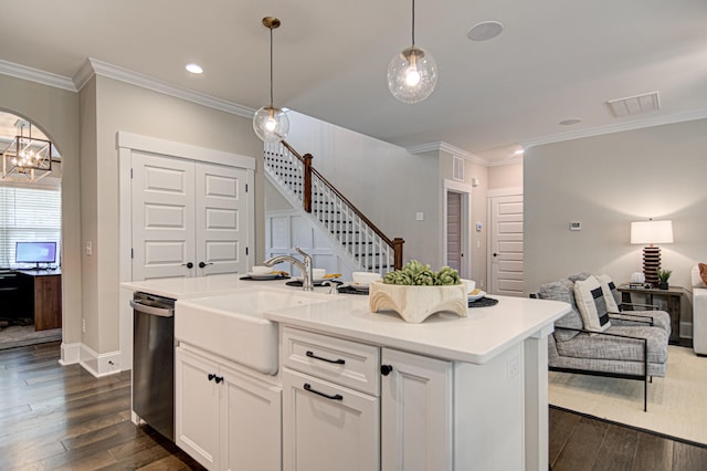 kitchen with white cabinets, dark hardwood / wood-style floors, a kitchen island with sink, and dishwasher