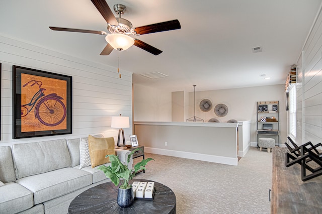 carpeted living room featuring ceiling fan