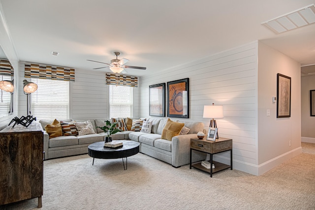 living room with ceiling fan and light colored carpet