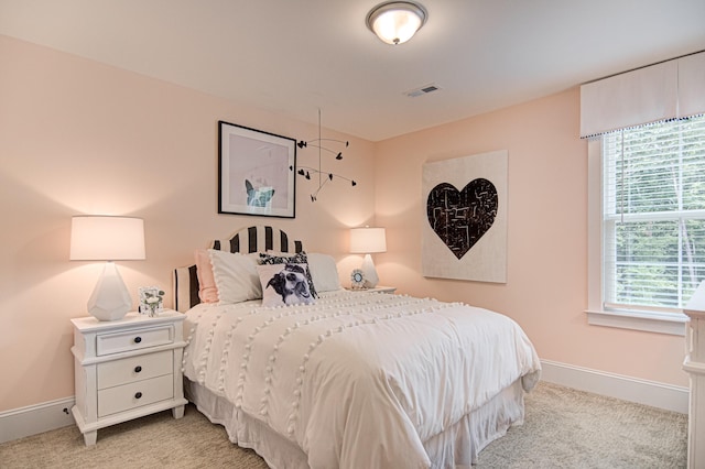 bedroom featuring light carpet