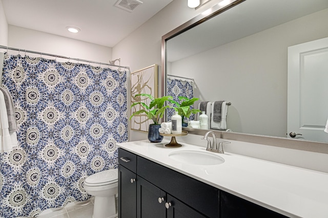 bathroom featuring tile patterned floors, vanity, and toilet