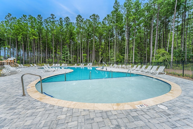 view of swimming pool with a patio area