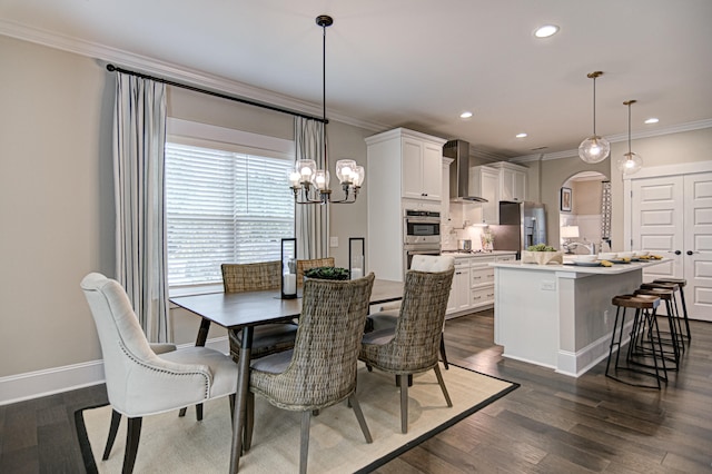 dining area featuring crown molding, dark hardwood / wood-style flooring, and a chandelier