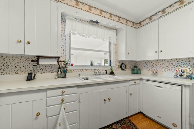 kitchen with sink, white cabinets, and white dishwasher