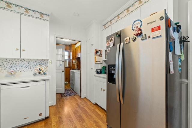 kitchen with white cabinets, crown molding, dishwasher, and stainless steel refrigerator with ice dispenser